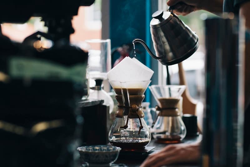 Dampende kop filterkoffie op houten tafel met koffiebonen ernaast